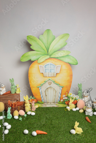 Background texture carrot Easter house in the shape of a carrot with bunny decorations.