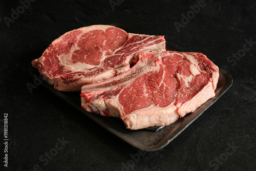 Fresh rip eyed steak on a black background.