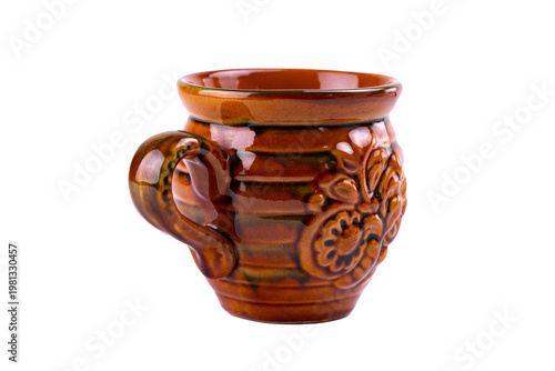 Vintage glazed ceramic mug produced by the famous Vasylkiv pottery plant, featuring traditional Ukrainian floral ornament and warm brown tones, isolated on white background.