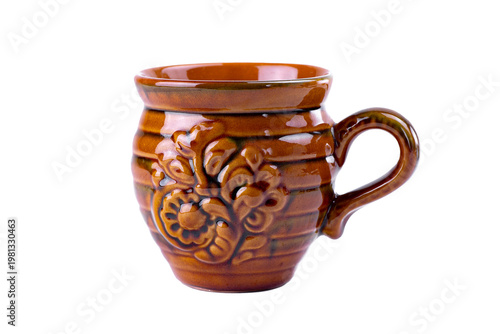 Vintage glazed ceramic mug produced by the famous Vasylkiv pottery plant, featuring traditional Ukrainian floral ornament and warm brown tones, isolated on white background.