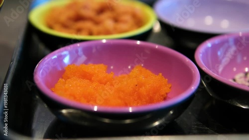 Sushi ingredients tray tempura shrimp sesame tuna salmon small fish Japanese cuisine