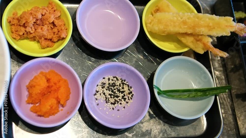 Sushi ingredients tray tempura shrimp sesame tuna salmon small fish Japanese cuisine