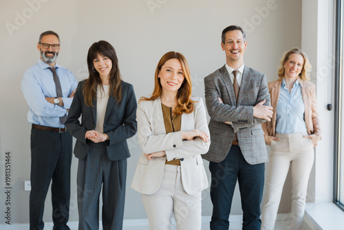 Obraz na plátně DIverse group of professional business people standing together in a modern office, smiling and posing confidently for the camera