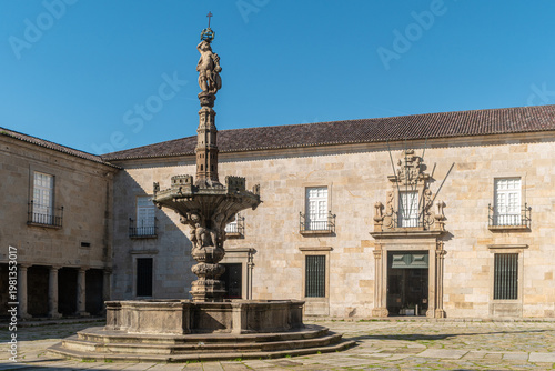 Wallpaper Mural A wide shot captures the ornate stone Manueline pillory fountain in the courtyard of the Episcopal Palace of Braga Portugal featuring historic granite architecture and traditional windows Torontodigital.ca