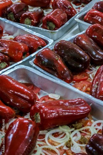Wallpaper Mural Red stuffed bell peppers arranged in metal trays, prepared with ingredients such as ground meat, onion, and tomato, ready for cooking.  Torontodigital.ca