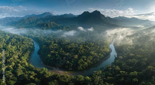 Misty Morning River Winding Through Lush Green Rainforest Mountains.