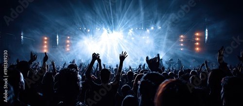 Crowd at Concert with Bright Stage Lights and Smoke in Night Atmosphere