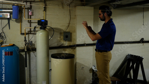 A Plumbing or Well Specialist Takes Photo of Water Filtration System