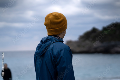 A man looks at the ocean, travels along the sea.