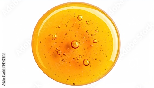 Golden liquid in a circle, with scattered air bubbles, on a white background