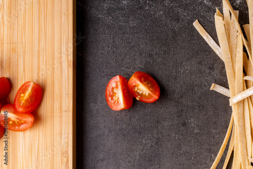 dried pasta and tomatoes prepped on a kitchen bench
