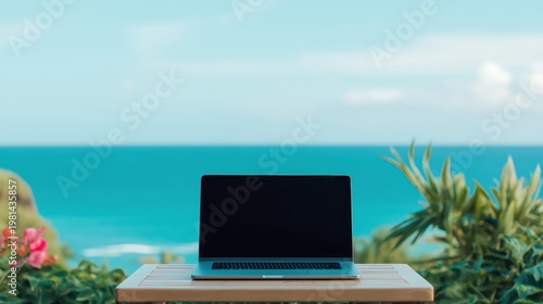 Laptop sitting on a wooden table with a beautiful turquoise ocean and blue sky in the background, symbolizing digital nomad lifestyle