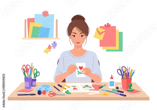Woman making greeting card at desk.