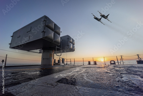 A military planes flies over a warship during a peacekeeping operation in the Black Sea.