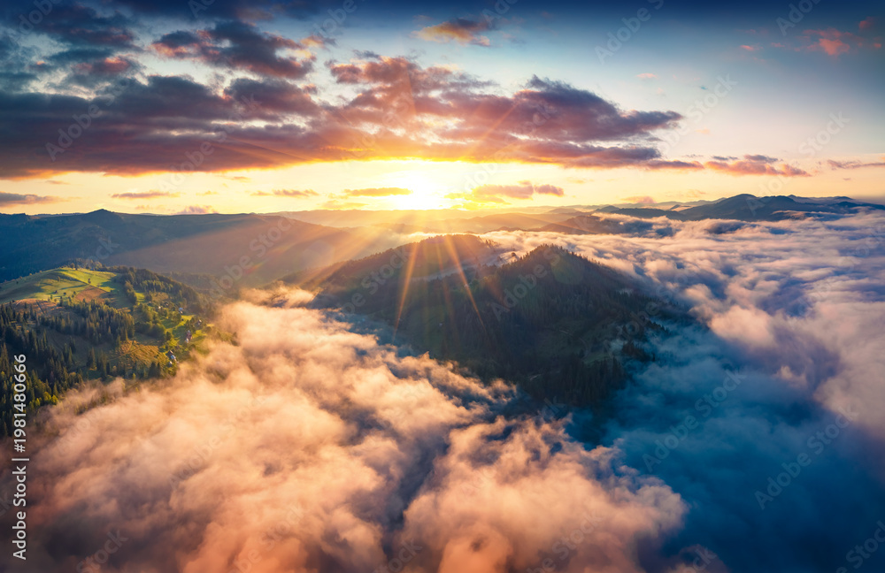 Naklejka premium Stunning sunrise on Carpathian mountains. Fog spreads on the valley of Snidavka village, Ukraine, Europe. Wonderful landscape of mountain hills. Beauty of nature concept background.