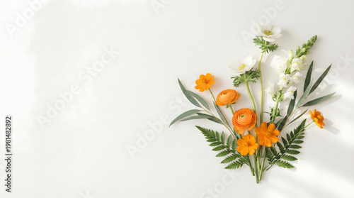 orange flowers and green leaves on white background