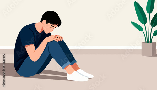 Young man sits hunched, head bowed in quiet distress. Hands clasped, eyes lowered, shoulders tense with unspoken sorrow. Soft lighting and minimalist room emphasize internal struggle
