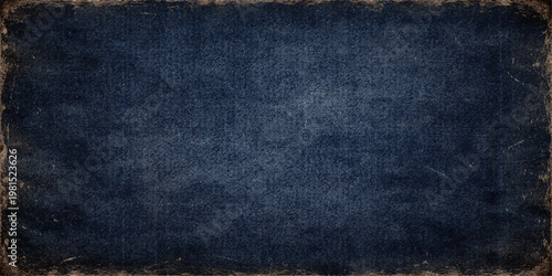 A dark blue vintage denim fabric texture background features a rough macro pattern of cotton textile material for a fashion clothing surface backdrop