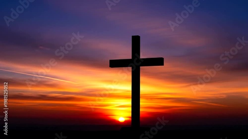 Silhouette of a Christian Cross Against a Dramatic Sunset Sky.