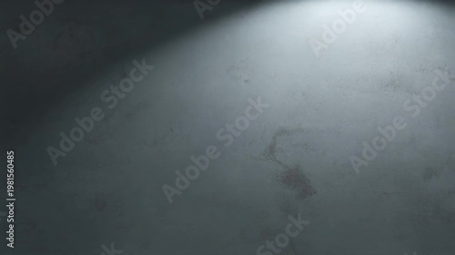 Empty textured concrete wall lit by a soft spotlight from above, moody minimalist background