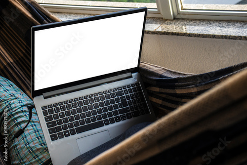 Wallpaper Mural Open laptop placed on a hammock inside a home, featuring a blank screen mockup. The image represents everyday technology use in a relaxed domestic environment, Torontodigital.ca