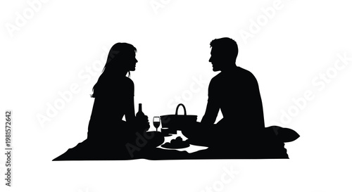 Silhouette of a couple enjoying a romantic picnic outdoors
