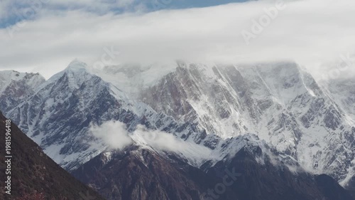 Landscape of Namcha Barwa, also known as the Killer Mountain, is one of the most majestic peaks in the world. Beautiful snow capped mountains in white clouds, 4k time lapse footage travel concept.