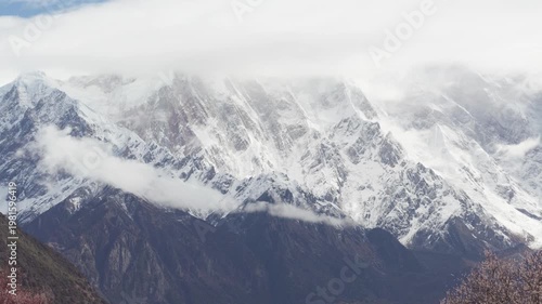 Landscape of Namcha Barwa, also known as the Killer Mountain, is one of the most majestic peaks in the world. Beautiful snow capped mountains in white clouds, 4k time lapse footage travel concept.
