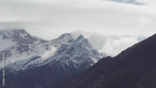 Landscape of Namcha Barwa, also known as the Killer Mountain, is one of the most majestic peaks in the world. Beautiful snow capped mountains in white clouds, 4k time lapse footage travel concept.