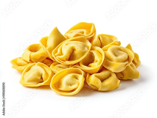 Heap of yellow, filled Italian pasta, resembling small hats, set on a white background