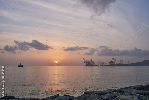 Sunrise over Gulf of Oman with Fujairah Port silhouettes in UAE