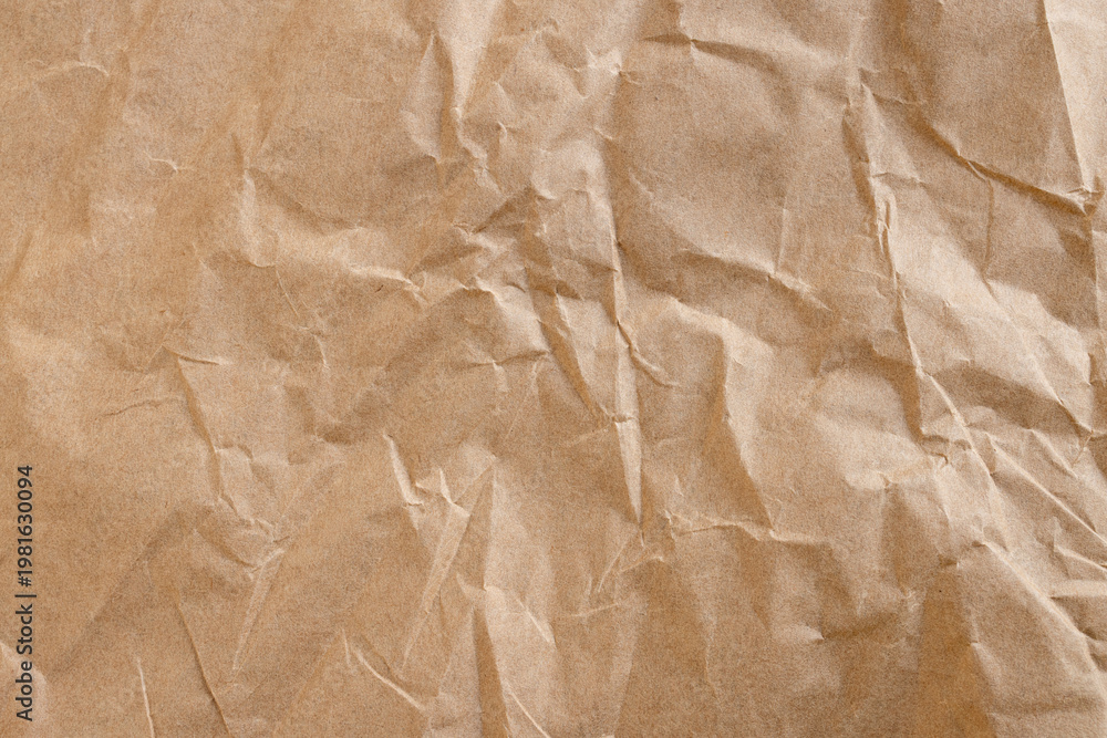 Obraz premium Top view of crumpled brown kraft paper texture background,Macro,A high-resolution, detailed texture of wrinkled and crumpled brown recycled paper, perfect for vintage backgrounds, eco-friendly concept