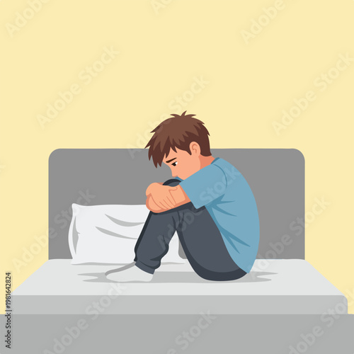 A sad young boy sitting hunched on a bed, feeling lonely and isolated at home