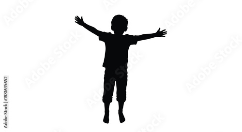Silhouette of a young boy jumping with arms outstretched in joy