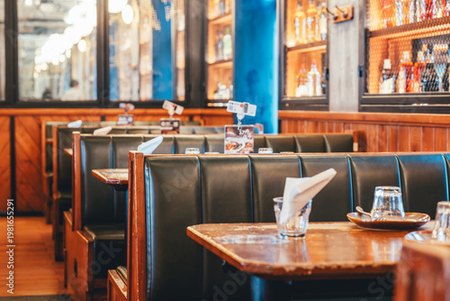Εκτύπωση καμβά Retro-style restaurant booth seating with wooden tables and leather upholstery