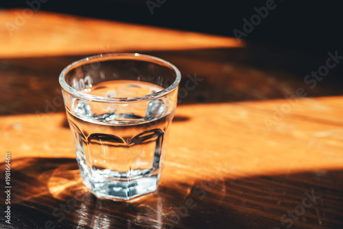 glass of water on the wooden table