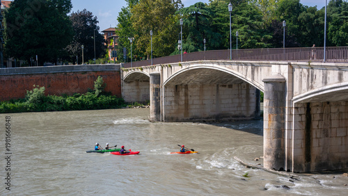 Kayaking in the river Adige in Verona passing underneath the Garibaldi bridge.