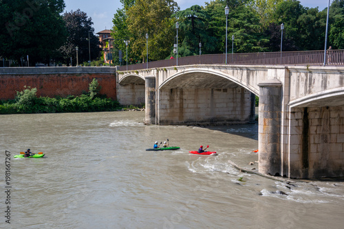 Kayaking in the river Adige in Verona passing underneath the Garibaldi bridge.