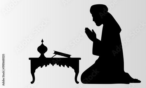  Black silhouette of person kneeling in prayer beside decorative table with open book and lamp on white background representing Islamic worship devotion and spirituality