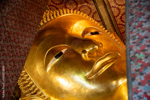 Konstfotografi Close-up view of the golden Reclining Buddha face inside Wat Pho, one of the most famous Buddhist temples in Bangkok, Thailand