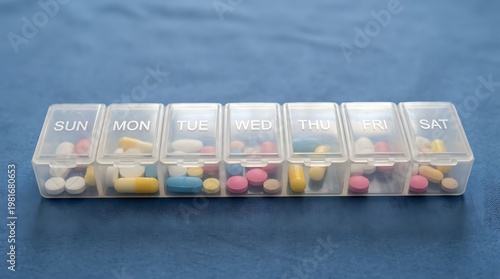 Weekly pill organizer with color coded medication compartments labeled by days of the week
