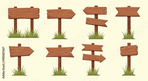 Collection of rustic wooden signboards and directional pointers with patches of green grass growing at the base of the posts.