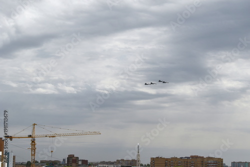 Military aircraft fly over the city