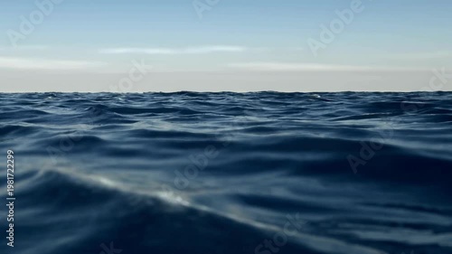 Vast expanse of dark blue ocean under a clear sky. Perfect for travel, nature, and peaceful concept designs.