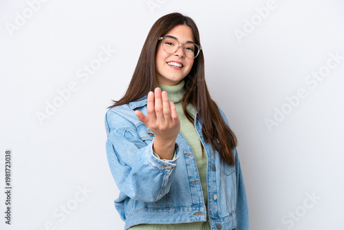 Young Brazilian woman isolated on white background inviting to come with hand. Happy that you came