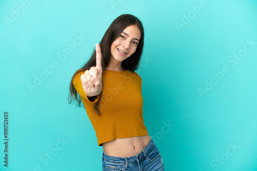 Young French woman isolated on blue background showing and lifting a finger