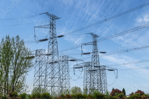 Wallpaper Mural Multiple Steel Transmission Towers with Overhead Power Lines Against Clear Blue Sky Torontodigital.ca