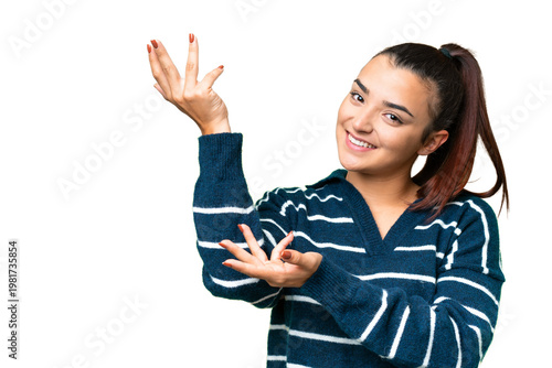 Young beauty woman over isolated chroma key background extending hands to the side for inviting to come