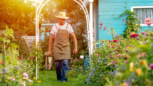 Sunlight glows through garden archway as man walks