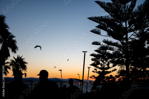 Photos Sunset view of Scarborough Beach in Perth, Australia with silhouette of people,